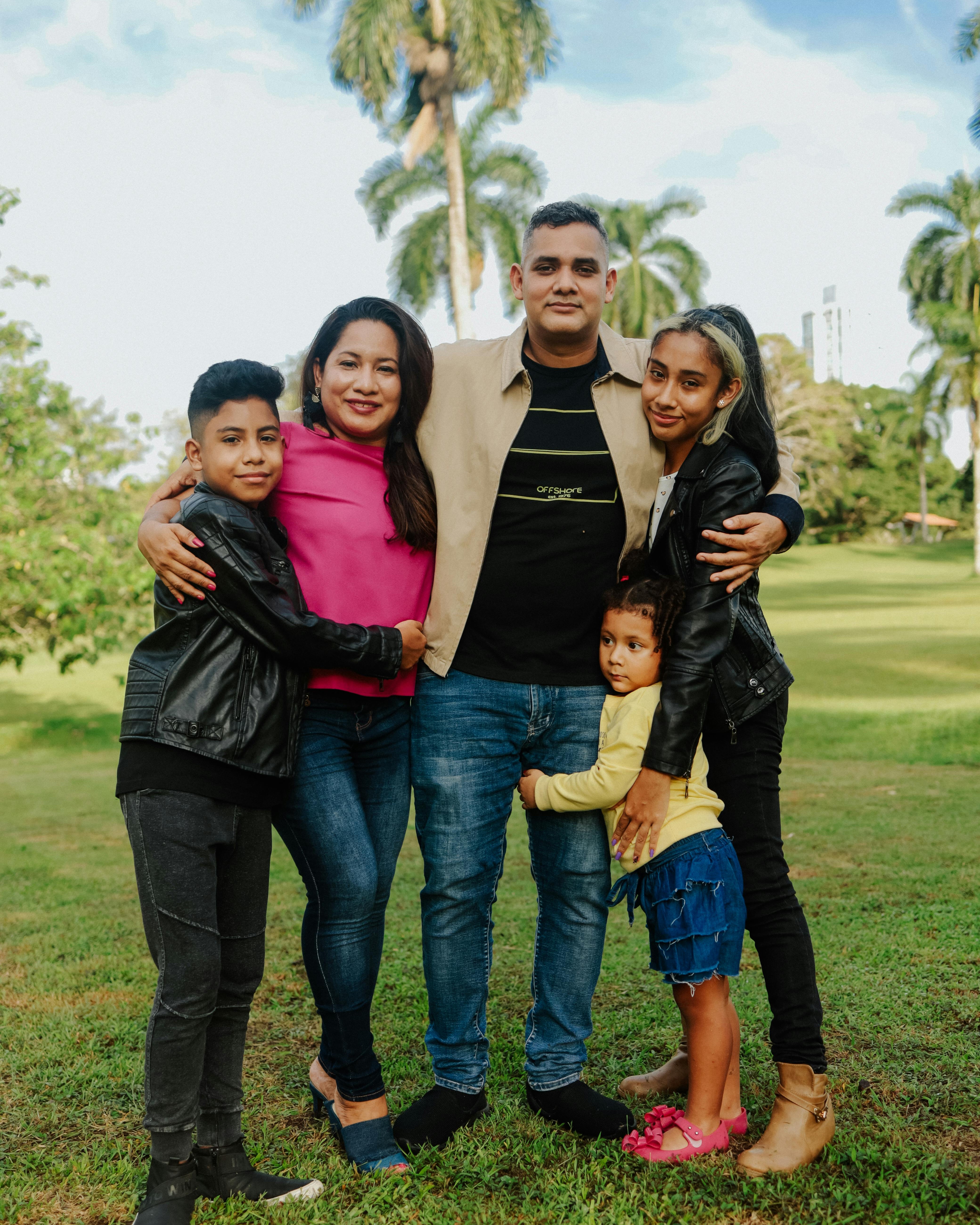 Happy Hispanic family of four smiling together