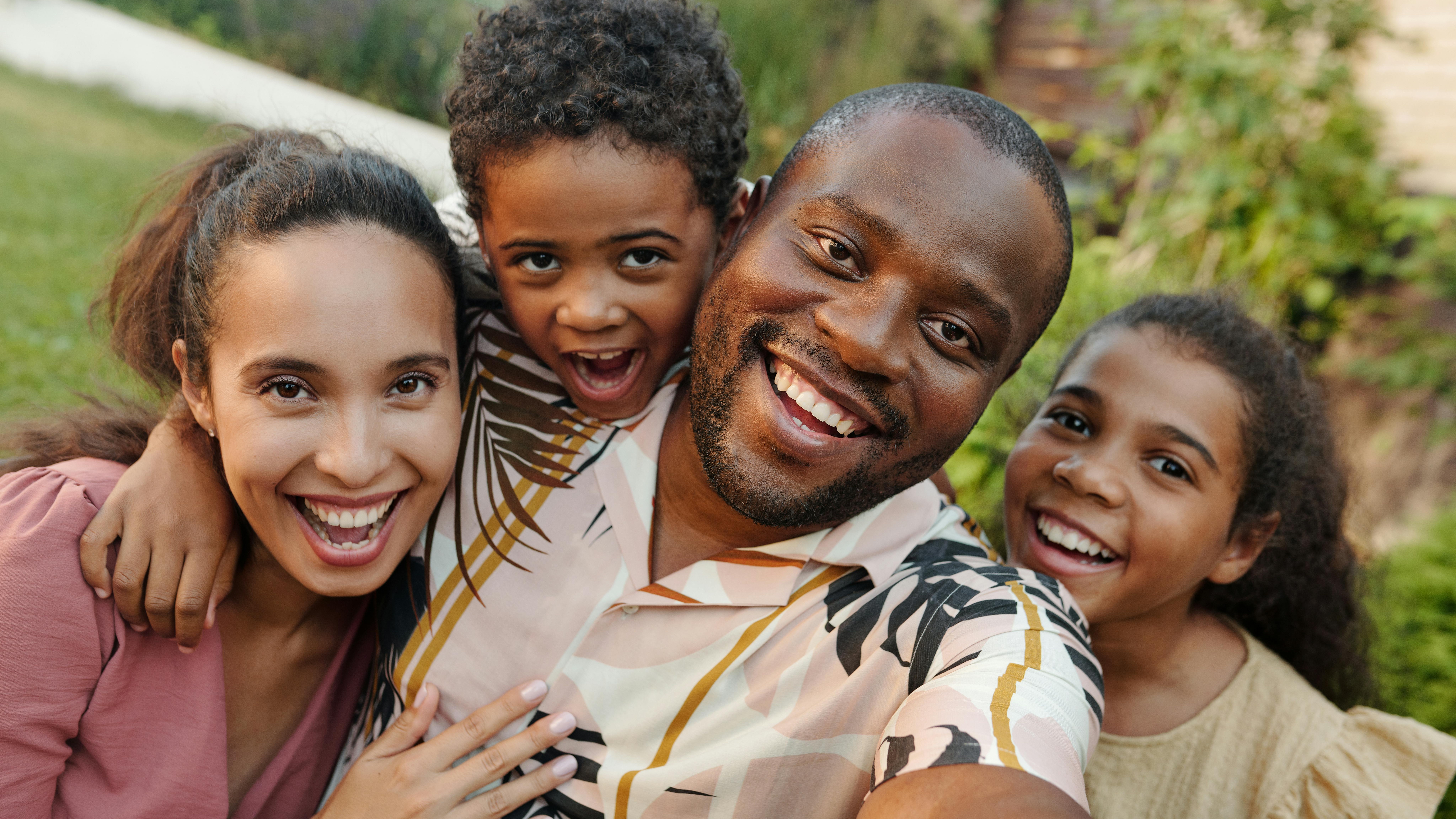 Happy multigenerational Hispanic family embracing together at home
